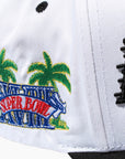 Detailed shot of side on two tone hat. Red, Blue, yellow and green palm tree design.