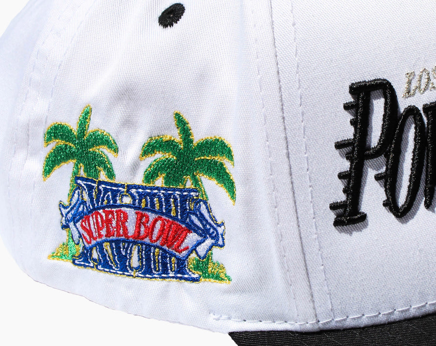 Detailed shot of side on two tone hat. Red, Blue, yellow and green palm tree design.